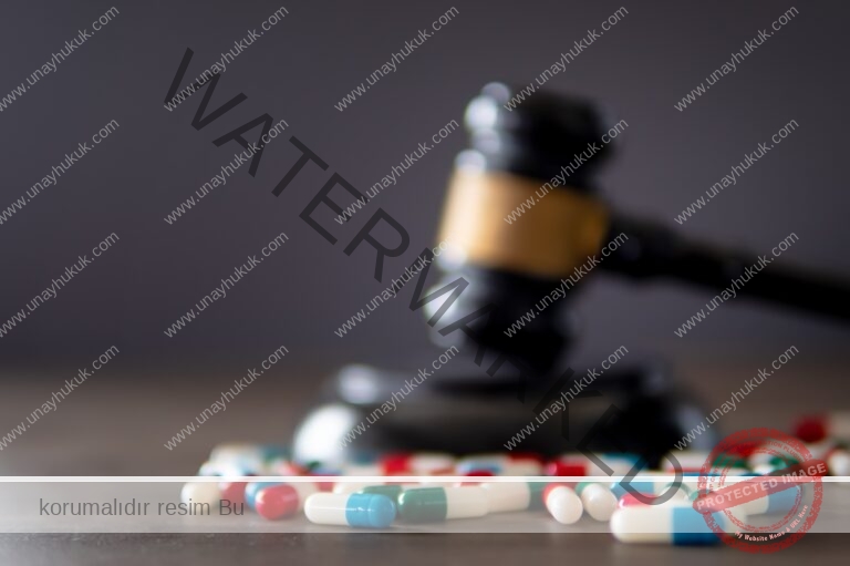 Closeup image of colorful medicine pills and judge gavel on table.